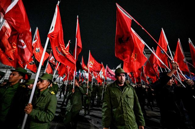 Cuban soldiers wave flags as they take part in the Torchlight March on the 173rd anniversary of National Hero Jose Marti (a leader of Cuba’s independence from Spain and founder of the Cuban Revolutionary Party) in Havana on January 27, 2026. (Photo by ADALBERTO ROQUE / AFP)