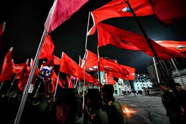 Cuban soldiers wave flags as they take part in the Torchlight March on the 173rd anniversary of National Hero Jose Marti (a leader of Cuba’s independence from Spain and founder of the Cuban Revolutionary Party) in Havana on January 27, 2026. (Photo by ADALBERTO ROQUE / AFP)