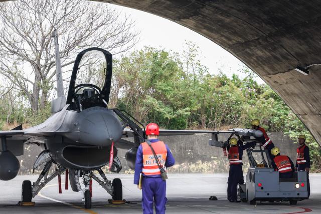 An AIM-120 Advanced Medium-Range Air-to-Air missile is being loaded to a F-16V fighter jet during a spring military exercise at Chiayi Air Base, in Chiayi on January 28, 2026. (Photo by I-Hwa Cheng / AFP)