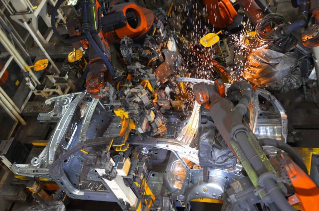 Robot arms assemble vehicles on a production line at a FAW-Volkswagen factory in Qingdao, in China’s eastern Shandong province on January 27, 2026. (Photo by -STR / AFP) / China OUT