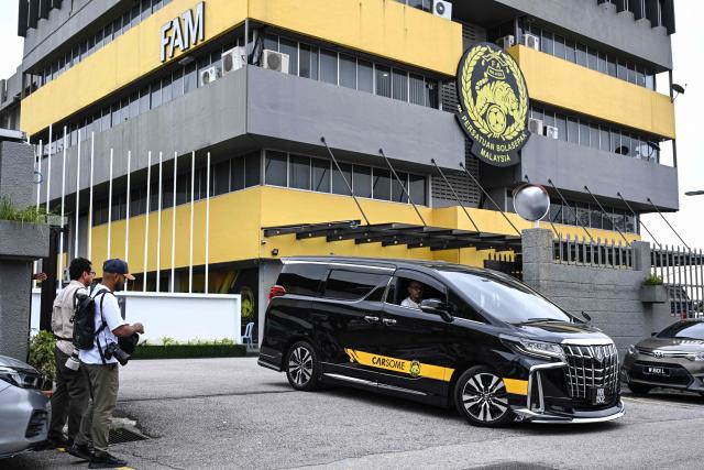 A vehicle of the Malaysian football association (FAM) leaves the FAM's headquarters in Kuala Lumpur on January 28, 2026. The Malaysian football association's entire executive committee resigned on January 28, due to an ongoing eligibility scandal linked to forged documents used in Asian Cup qualifying games. (Photo by Mohd Rasfan / AFP)