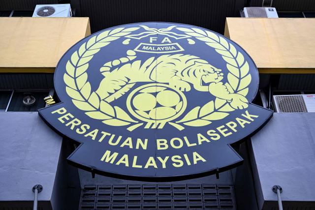 The logo of the Malaysian football association (FAM) is pictured at the FAM's headquarters in Kuala Lumpur on January 28, 2026. The Malaysian football association's entire executive committee resigned on January 28, due to an ongoing eligibility scandal linked to forged documents used in Asian Cup qualifying games. (Photo by Mohd Rasfan / AFP)