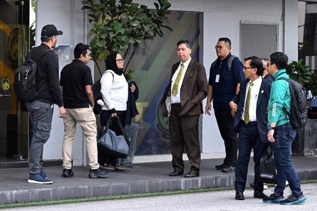 Members of the Malaysian football association's (FAM) executive committee Kamarudin Hassan (2nd R), Hisamudin Yahaya (C) and Siti Faidul Maisarah Abdullah (3rd L) leave after resigning at the FAM's headquarters in Kuala Lumpur on January 28, 2026. The Malaysian football association's entire executive committee resigned on January 28, due to an ongoing eligibility scandal linked to forged documents used in Asian Cup qualifying games. (Photo by Mohd Rasfan / AFP)