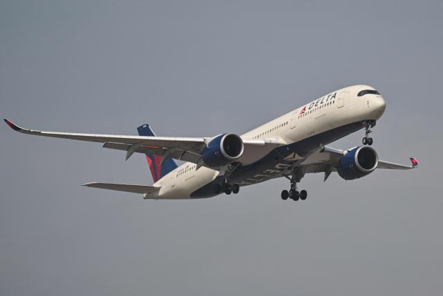 (FILES) An Airbus A350-941 of Delta Airlines prepares to land at Shanghai Pudong International Airport in Shanghai on April 16, 2025. The American airline Delta Air Lines has placed a firm order for 31 new long-haul aircraft with Airbus, the European aircraft manufacturer announced on January 28, 2026. (Photo by HECTOR RETAMAL / AFP)