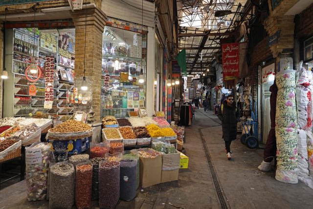 A man walks past the stores in Tajrish Bazaar, in Tehran on January 28, 2026. (Photo by ATTA KENARE / AFP)