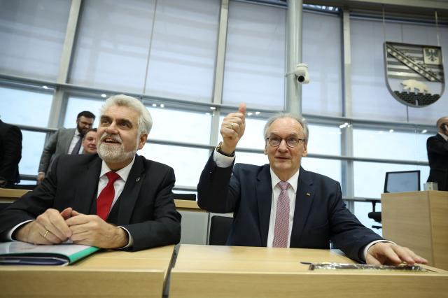 Saxony-Anhalt's outgoing State Premier Reiner Haseloff (R) gives the thumbs-up next to Saxony-Anhalt's Econimy Minister Armin Willingmann at Saxony-Anhalt's State Parliament, on January 28, 2026 in Magdeburg, eastern Germany, prior to the election of the new regional leader. After roughly 15 years in office, Haseloff will not run in Saxony-Anhalt's state elections scheduled on September 6, 2026. (Photo by Ronny HARTMANN / AFP)