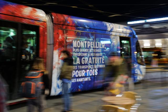 (FILES) This photograph taken on December 21, 2023, shows a tramway with a message reading "Equality, freedom, solidarity, ecology, it doesn't have a cost, Bus and Trams free" running on tracks in Montpellier, southern France. Free transportation is a popular idea for the March municipal elections in many cities. But the promises vary greatly, and some candidates denounce it as “vote fishing” or even a “false good idea.” (Photo by Sylvain THOMAS / AFP)