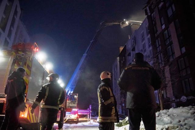 Ukrainian rescuers work to extinguish a fire in a residential building following a drone attack in Bilohorodka, Kyiv region on January 28, 2026, amid the Russian invasion of Ukraine.  (Photo by Serhii Okunev / AFP)
