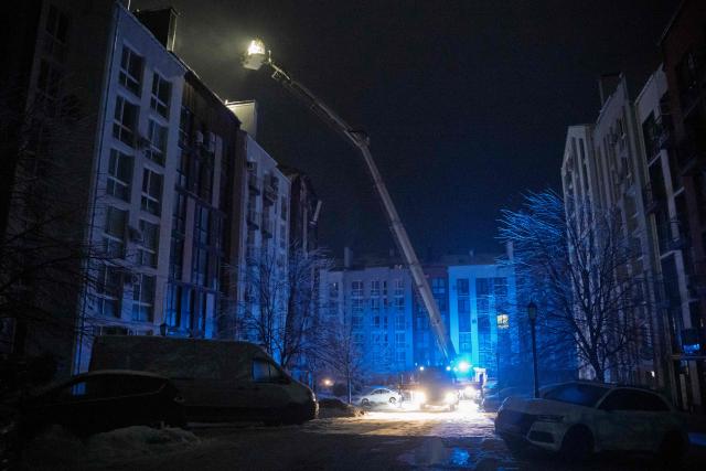 Ukrainian rescuers work to extinguish a fire in a residential building following a drone attack in Bilohorodka, Kyiv region on January 28, 2026, amid the Russian invasion of Ukraine.  (Photo by Serhii Okunev / AFP)