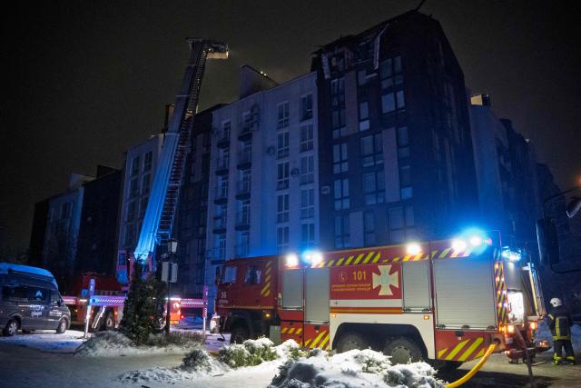 Ukrainian rescuers work to extinguish a fire in a residential building following a drone attack in Bilohorodka, Kyiv region on January 28, 2026, amid the Russian invasion of Ukraine.  (Photo by Serhii Okunev / AFP)