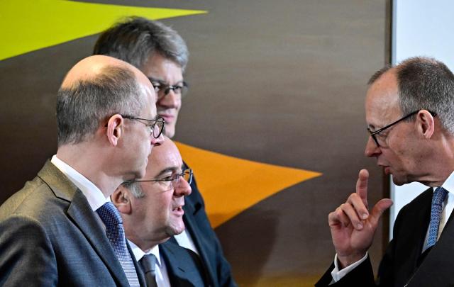 German Chancellor Friedrich Merz (R) talks with German Defence Minister Boris Pistorius (2nd L) prior to the weekly cabinet meeting on January 28, 2026 at the Chancellery in Berlin. (Photo by Tobias SCHWARZ / AFP)
