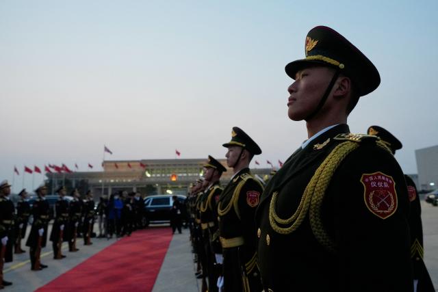 Chinese honour guards prepare for the arrival of Britain's Prime Minister Keir Starmer at an airport in Beijing on January 28, 2026. British Prime Minister Keir Starmer arrived in Beijing on January 28 to meet with Chinese leader Xi Jinping, hoping to restore long fraught relations. (Photo by Kin Cheung / POOL / AFP)