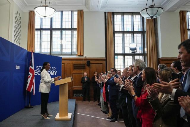 Attendees applaud as Britain's main opposition Conservative Party leader Kemi Badenoch (L) speaks at a party event in central London on January 28, 2026. (Photo by CARLOS JASSO / AFP)