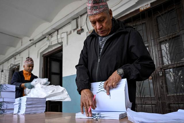 Workers sort materials at the Election Commission's office ahead of parliamentary elections in Kathmandu on January 28, 2026. Nepal's Election Commission said on January 28 it is ready to hold elections as planned, despite concerns that its unusually early-year timing could bring "challenging" conditions to high-altitude Himalayan regions. (Photo by Prakash MATHEMA / AFP)