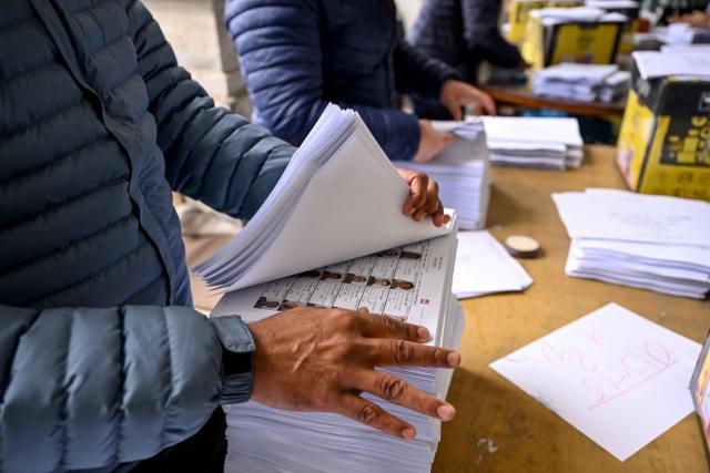 Workers sort bundles of voter slips at the Election Commission's office ahead of parliamentary elections in Kathmandu on January 28, 2026. Nepal's Election Commission said on January 28 it is ready to hold elections as planned, despite concerns that its unusually early-year timing could bring "challenging" conditions to high-altitude Himalayan regions. (Photo by Prakash MATHEMA / AFP)