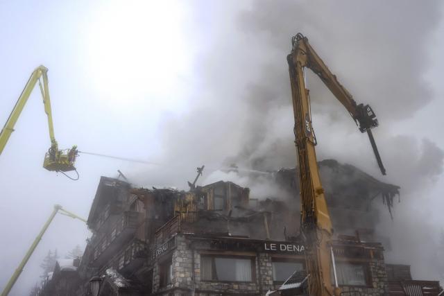 Firefighters work on a fire that broke out the evening before at the five-star Grandes Alpes hotel in the upscale French Alpine ski resort of Courchevel, forcing the evacuation of 83 occupants, on January 28, 2026. More than a hundred firefighters were still working on January 28 morning to bring under control the violent fire, which origin remains undetermined, and nearly 300 people were evacuated. (Photo by Alex MARTIN / AFP)