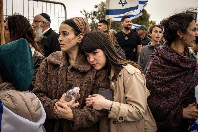 TOPSHOT - Mourners gather for the funeral of Israeli hostage Ran Gvili, whose remains were finally brought back to Israel on January 26, in the southern town of Meitar on January 28, 2026. Grieving relatives of Ran Gvili gathered on January 28, 2026, as Israel prepared to bury the last hostage returned from Gaza, marking the end of a painful national saga triggered by Hamas's 2023 attack. Israeli forces on January 26 brought home the remains of Gvili, a police officer who was killed in action during Hamas's attack on October 7, 2023 which triggered the devastating war in Gaza. (Photo by JOHN WESSELS / AFP)