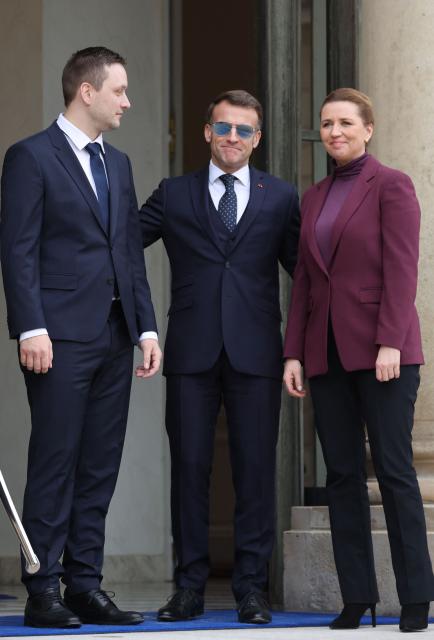 France's President Emmanuel Macron (C) welcomes Greenland’s Prime Minister Jens-Frederik Nielsen (L) and Denmark's Prime Minister Mette Frederiksen (R) for a working lunch at the Elysee Palace in Paris, on January 28, 2026. (Photo by Ludovic MARIN / AFP)