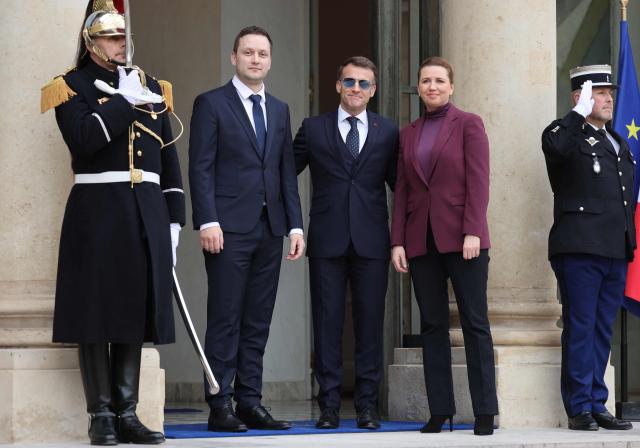 France's President Emmanuel Macron (C) welcomes Greenland’s Prime Minister Jens-Frederik Nielsen (C-L) and Denmark's Prime Minister Mette Frederiksen (C-R) for a working lunch at the Elysee Palace in Paris, on January 28, 2026. (Photo by Ludovic MARIN / AFP)