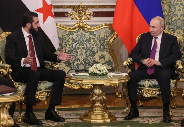 Russian President Vladimir Putin meets with Syria's President Ahmed al-Sharaa at the Kremlin in Moscow on January 28, 2026. (Photo by MAXIM SHIPENKOV / POOL / AFP)