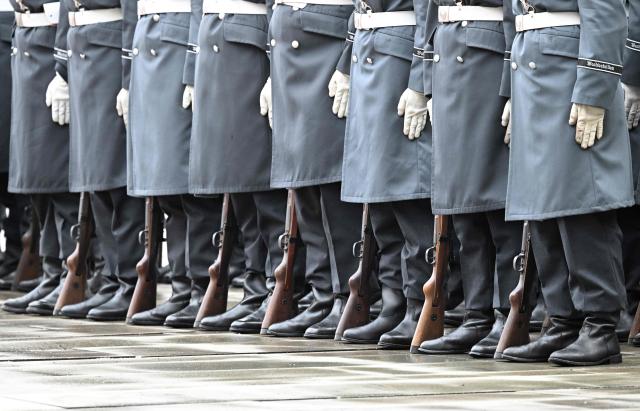 Soldiers of an honor guard of the German armed forces Bundeswehr stand guard prior to a visit of Romania's Prime Minister at the German Chancellor's office, in Berlin on January 28, 2026. (Photo by RALF HIRSCHBERGER / AFP)