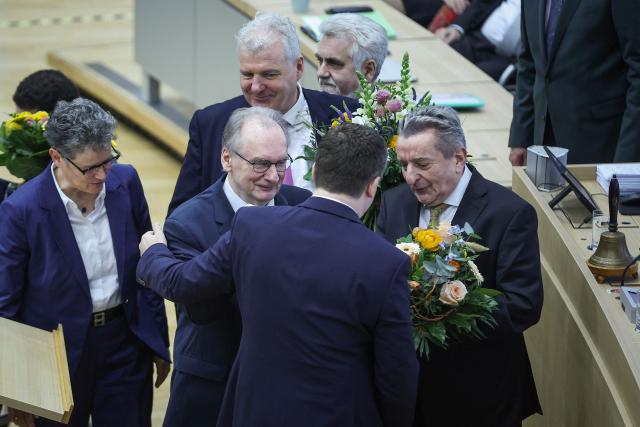 Saxony-Anhalt's incoming State Premier Sven Schulze (C) is congratulated by Saxony-Anhalt's outgoing State Premier Reiner Haseloff (2nd L) and State parliament President Gunnar Schellenberger (R) at Saxony-Anhalt's State Parliament, on January 28, 2026 in Magdeburg, eastern Germany, after he was elected as the new regional leader. After roughly 15 years in office, Saxony-Anhalt's outgoing State Premier Reiner Haseloff  will not run in Saxony-Anhalt's state elections scheduled on September 6, 2026. (Photo by RONNY HARTMANN / AFP)