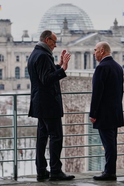 German Chancellor Friedrich Merz welcomes Romanian Prime Minister Ilie Bolojan at the chancellery in Berlin, on Jannuary 28, 2026. (Photo by Ebrahim Noroozi / POOL / AFP)