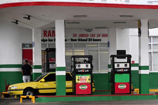A man buys fuel at a gas station in Havana, on January 28, 2026. (Photo by YAMIL LAGE / AFP)