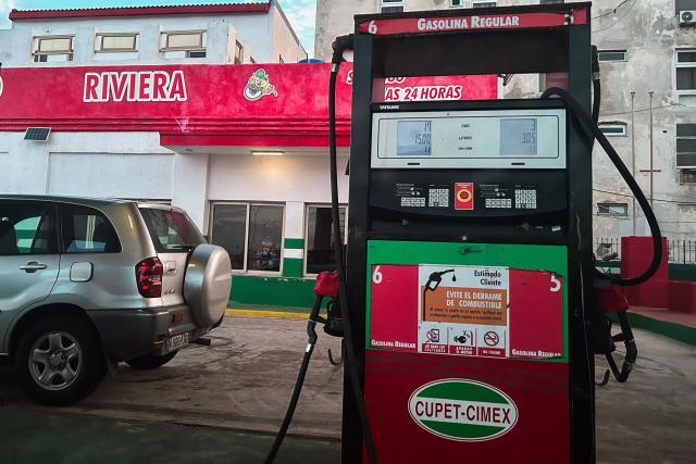 A vehicle fills up with fuel at a gas station in Havana on January 28, 2026. (Photo by YAMIL LAGE / AFP)