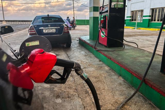 A vehicle fills up with fuel at a gas station in Havana on January 28, 2026. (Photo by YAMIL LAGE / AFP)