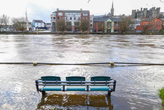 Water from the River Slaney surrounds a bench on the bank of the river after it burst its banks during Strom Chandra, in Enniscorthy, near Wexford, south east Ireland on January 28, 2026. (Photo by Paul Faith / AFP)