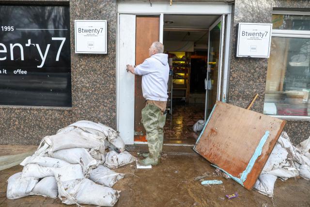 A person works to clear flood-damaged items from a property after the River Slaney burst its banks during Strom Chandra, in Enniscorthy, near Wexford, south east Ireland on January 28, 2026. (Photo by Paul Faith / AFP)