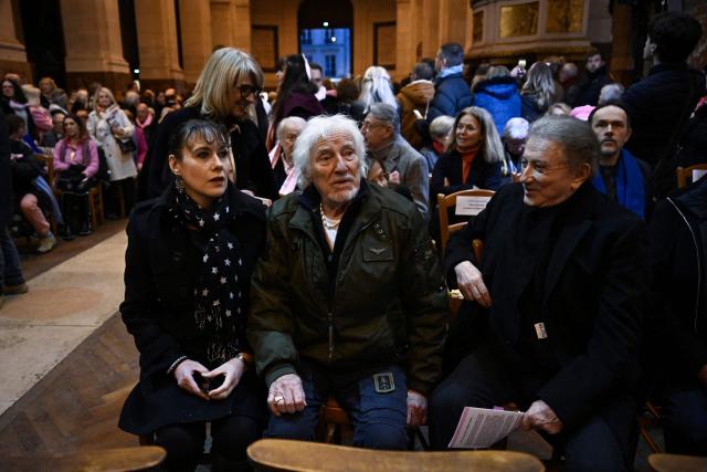 French singer, songwriter, and composer Hugues Aufray (C) and French TV host Michel Drucker (R) attend a memorial mass for late French actress Brigitte Bardot at Saint-Roch church in Paris, on January 28, 2026. (Photo by JULIEN DE ROSA / AFP)