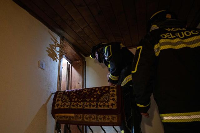 Firefighters check an evacuated house in the red zone of the city centre following a landslide that damaged homes in Niscemi on January 28, 2026. More than 1,000 people were evacuated in Sicily after a four-kilometre (2.5-mile) section of cliff crumbled during a storm, leaving houses perched perilously on the edge, authorities said on January 26, 2026. (Photo by MARCO BERTORELLO / AFP)