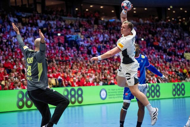 Germany's pivot #54 Justus Fischer (R) and France's goalkeeper #16 Charles Bolzinger (L) vie for the ball during the men's EHF Euro 2026 main round handball match Germany vs France in Herning, Denmark, on January 28, 2026. (Photo by Bo Amstrup / Ritzau Scanpix / AFP) / Denmark OUT