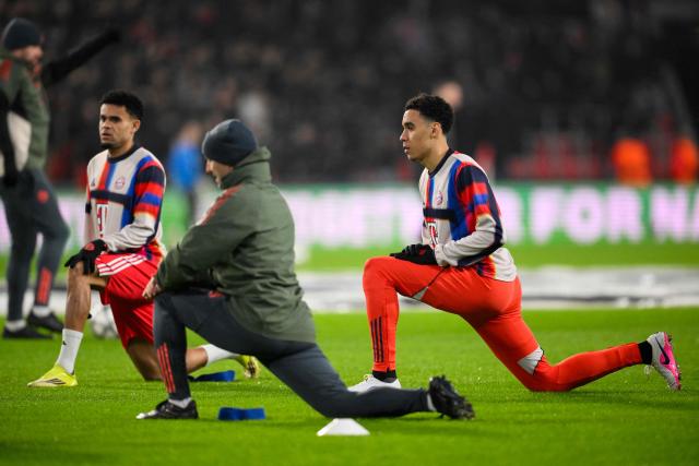 Bayern Munich's German midfielder #42 Jamal Musiala (R) warms up ahead of the UEFA Champions League league phase day 8 football match between PSV Eindhoven and Bayern Munich at Philips Stadion in Eindhoven on January 28, 2026. (Photo by JOHN THYS / AFP)