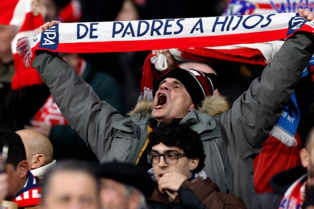 An Atletico Madrid fan holds up a scarf before the UEFA Champions League league phase day 8 football match between Club Atletico de Madrid and Bodoe/Glimt at Metropolitano Stadium in Madrid on January 28, 2026. (Photo by Oscar DEL POZO / AFP)