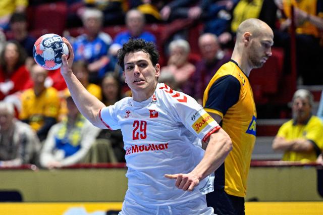 Switzerland's wing #29 Samuel Zehnder shoots the ball during the men's EHF Euro 2026 main round handball match Switzerland v Sweden in Malmoe, Sweden, on January 28, 2026. (Photo by Johan NILSSON / TT NEWS AGENCY / AFP) / Sweden OUT