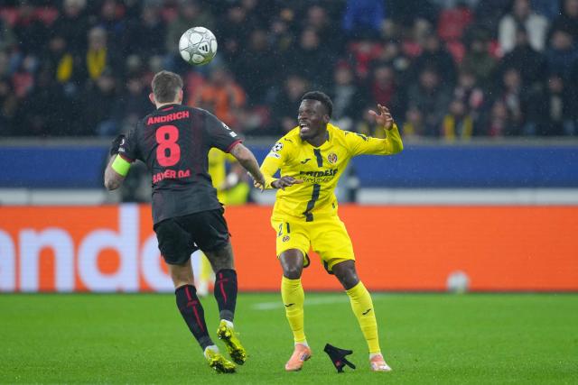 Bayer Leverkusen's German midfielder #08 Robert Andrich (L) and Villarreal's Canadian forward #21 Tani Oluwaseyi vie for the ball during the UEFA Champions League league phase - Day 8 football match between Bayer Leverkusen and Villarreal CF at the BayArena stadium in Leverkusen, western Germany on January 28, 2026. (Photo by Pau Barrena / AFP)