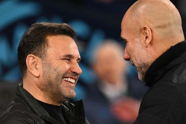 Manchester City's Spanish manager Pep Guardiola greets Galatasaray's Turkish head coach Okan Buruk ahead of the UEFA Champions League football match between Manchester City and Galatasaray at the Etihad Stadium in Manchester, north west England, on January 28, 2026. (Photo by Oli SCARFF / AFP)