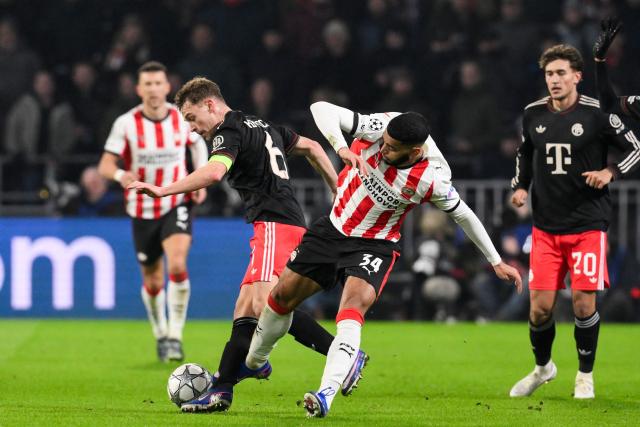 Bayern Munich's German midfielder #06 Joshua Kimmich (L) fights for the ball with PSV Eindhoven's Moroccan midfielder #34 Ismael Saibari during the UEFA Champions League league phase day 8 football match between PSV Eindhoven and Bayern Munich at Philips Stadion in Eindhoven on January 28, 2026. (Photo by JOHN THYS / AFP)