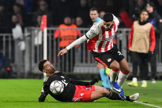 Bayern Munich's German midfielder #10 Jamal Musiala fights for the ball with PSV Eindhoven's Moroccan midfielder #34 Ismael Saibari during the UEFA Champions League league phase day 8 football match between PSV Eindhoven and Bayern Munich at Philips Stadion in Eindhoven on January 28, 2026. (Photo by JOHN THYS / AFP)