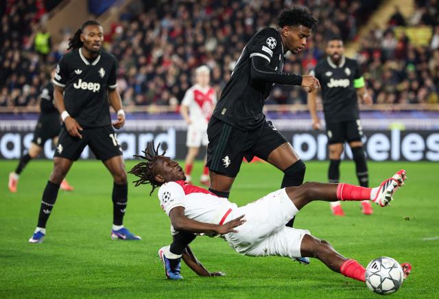 Monaco's French midfielder #28 Mamadou Coulibaly (DOWN) fights for the ball with Juventus' Colombian defender #32 J Cabal during the UEFA Champions League league phase day 8 football match between AS Monaco and Juventus at the Stade Louis II in the Principality of Monaco on January 28, 2026. (Photo by Valery HACHE / AFP)