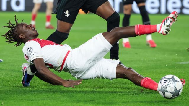 Monaco's French midfielder #28 Mamadou Coulibaly falls as he fights for the ball with Juventus' Colombian defender #32 J Cabal during the UEFA Champions League league phase day 8 football match between AS Monaco and Juventus at the Stade Louis II in the Principality of Monaco on January 28, 2026. (Photo by Valery HACHE / AFP)
