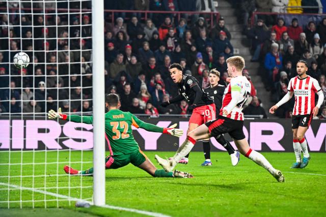 Bayern Munich's German midfielder #10 Jamal Musiala shoots and scores his team's first goal during the UEFA Champions League league phase day 8 football match between PSV Eindhoven and Bayern Munich at Philips Stadion in Eindhoven on January 28, 2026. (Photo by JOHN THYS / AFP)