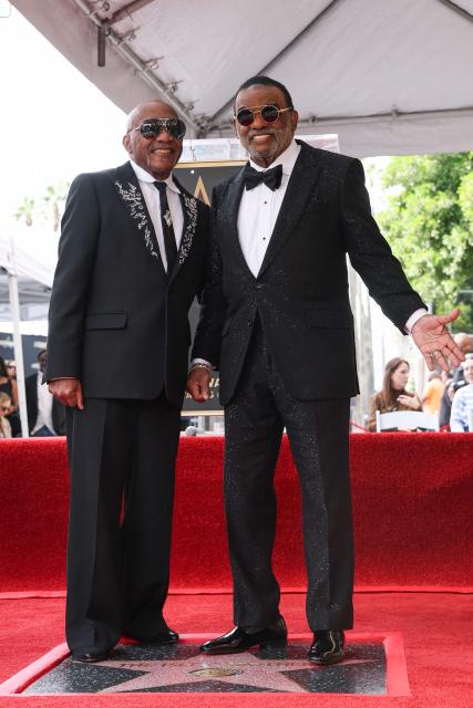 US singer-songwriters Ronald Isley (R) and Ernie Isley (L) of US band The Isley Brothers pose on their newly unveilled star on the Walk of Fame in Hollywood, California on January 28, 2026. (Photo by VALERIE MACON / AFP)