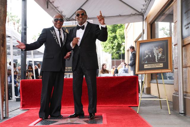 US singer-songwriters Ronald Isley (R) and Ernie Isley (L) of US band The Isley Brothers pose on their newly unveilled star on the Walk of Fame in Hollywood, California on January 28, 2026. (Photo by VALERIE MACON / AFP)