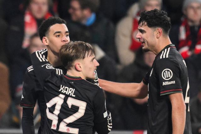 (From L) Bayern Munich's German midfielder #10 Jamal Musiala celebrates after scoring his team's first goal with Bayern Munich's German midfielder #42 Lennart Karl and Bayern Munich's German midfielder #45 Aleksandar Pavlovic during the UEFA Champions League league phase day 8 football match between PSV Eindhoven and Bayern Munich at Philips Stadion in Eindhoven on January 28, 2026. (Photo by JOHN THYS / AFP)