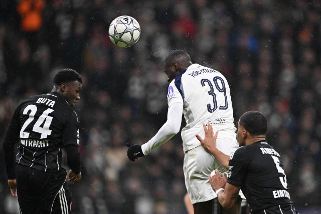 Tottenham Hotspur's French striker #39 Randal Kolo Muani vies for the ball with Frankfurt's Portuguese defender #24 Aurelio Buta and Frankfurt's Swiss-Cameroonian defender #05 Aurele Amenda during the UEFA Champions League league phase- day 8 football match between Eintracht Frankfurt and Tottenham Hotspur in Frankfurt, western Germany, on January 28, 2026. (Photo by Kirill KUDRYAVTSEV / AFP)