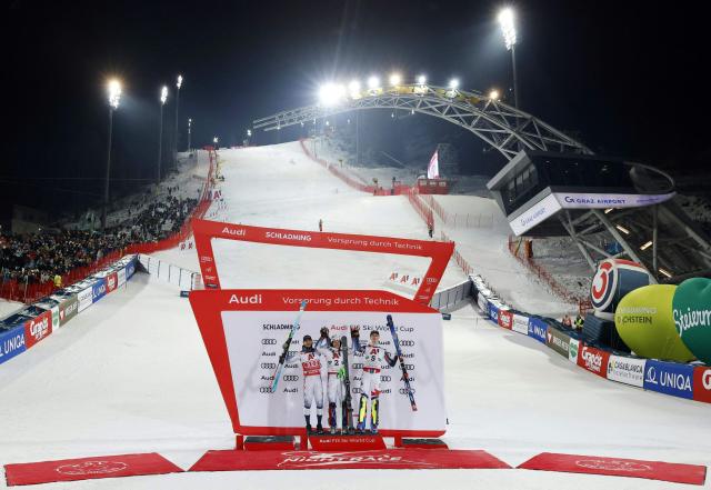 (L-R) Second placed Norway's Atle Lie Mcgrath, first placed Norway's Henrik Kristoffersen and third places France's Clement Noel celebrate on the podium after winning the second run of the men's Slalom event of FIS Alpine Skiing World Cup in Schladming, Austria, on January 28, 2026. (Photo by ERWIN SCHERIAU / APA / AFP) / Austria OUT